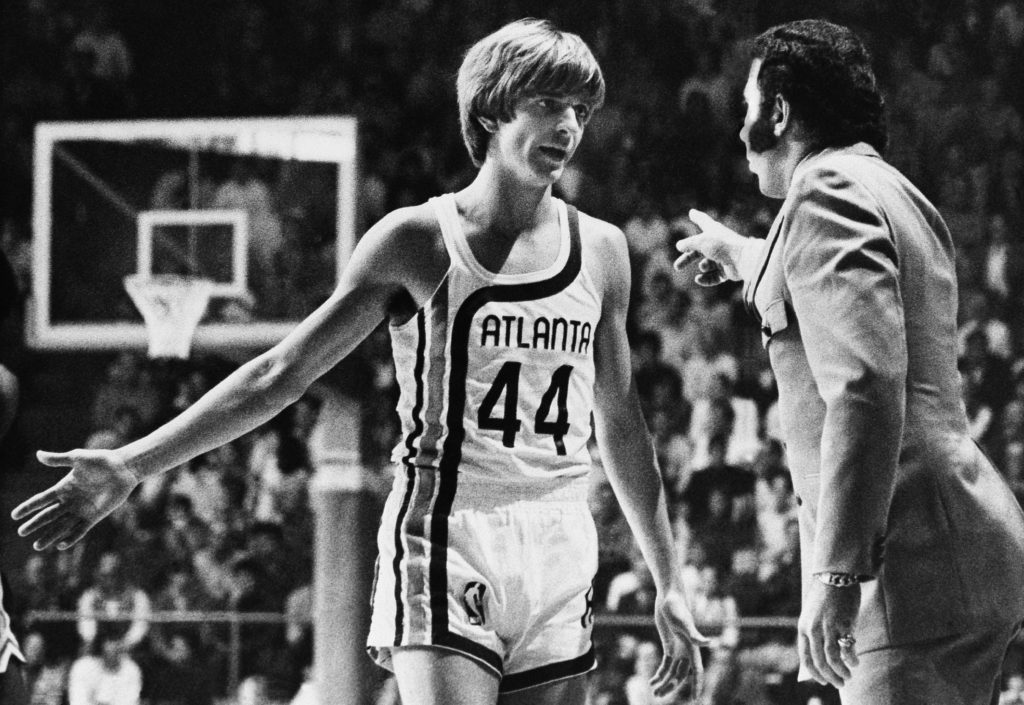 Before making his debut into professional basketball, "Pistol" Pete Maravich receives last minute instructions from Coach Richie Guerin, in Atlanta, Oct. 20, 1970. Maravich spent the first quarter of the Atlanta Hawks-Milwaukee Bucks game on the bench. (AP Photo/Toby Massey)